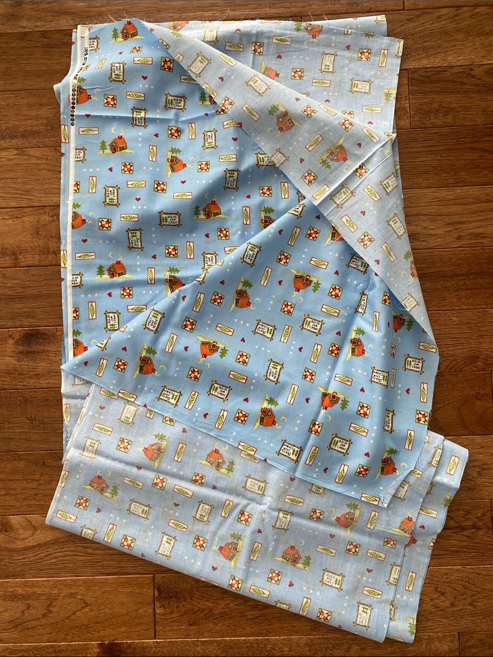 18 ft. Light Blue Novelty Cotton Fabric with Cabin Print